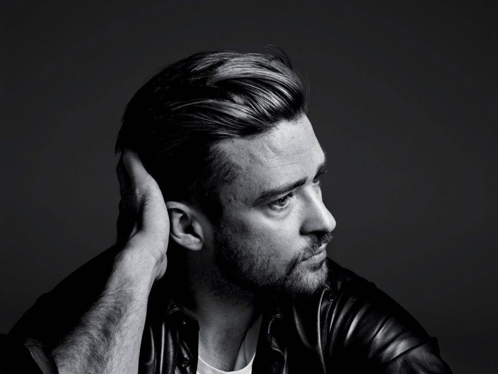 Monochrome portrait of Justin Timberlake with textured pompadour hairstyle and dramatic lighting Wallpaper