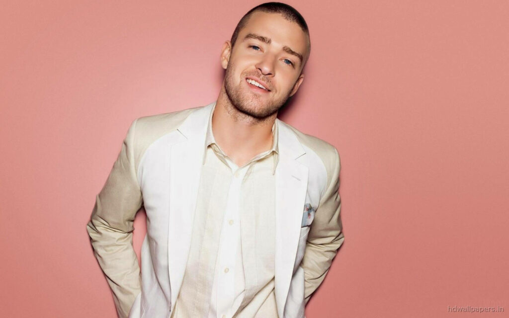 Justin Timberlake's Charming All-White Look on Soft Pink Wallpaper