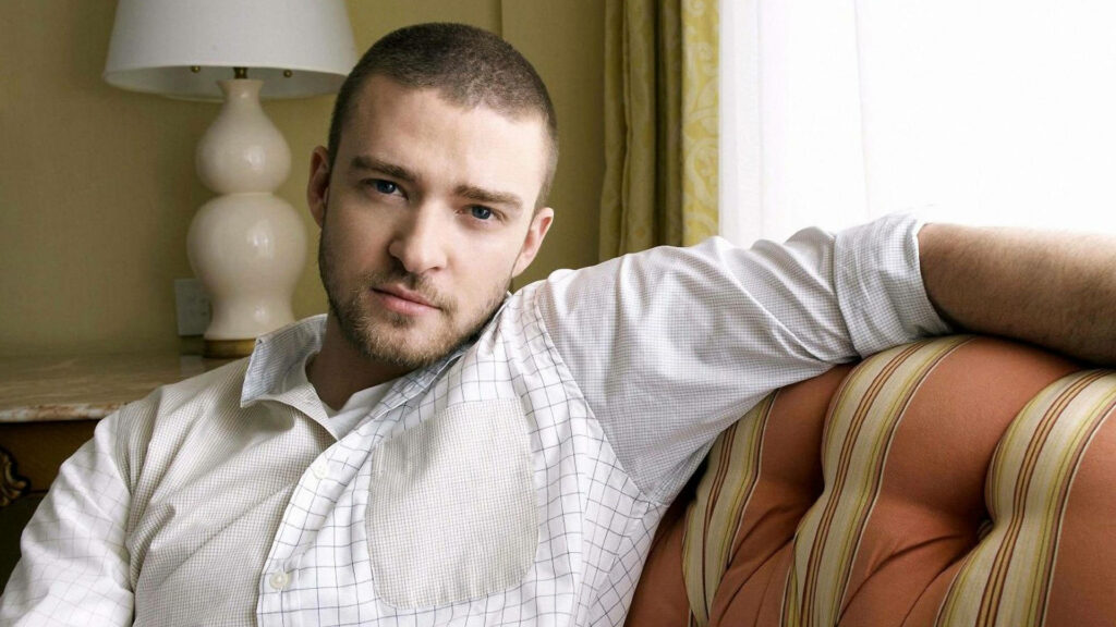 Justin Timberlake Relaxes on Stylish Striped Sofa in Chic Room Wallpaper