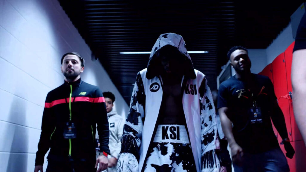 KSI walking confident in hooded robe with boxing gear name showcasing athlete influencer image Wallpaper