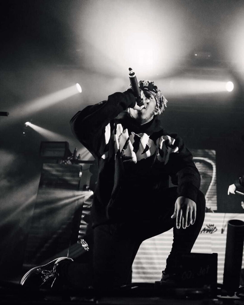 KSI energetic on stage at gaming tournament British influencer boxer musician YouTuber wallpaper