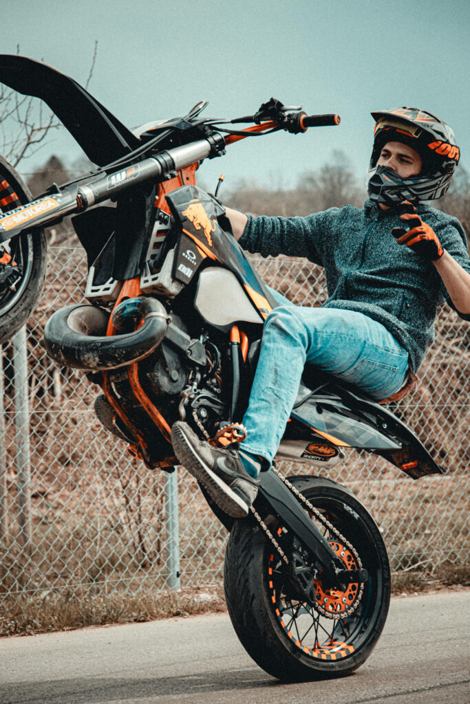 KTM Bike Wheelie Stunt Wallpaper - Vibrant Orange & Black Action