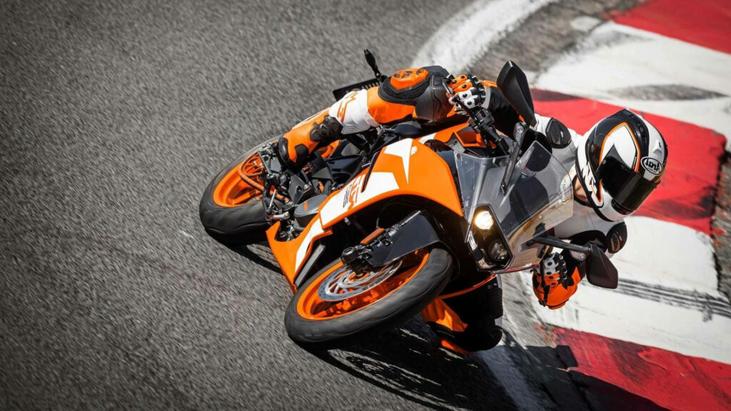 Vibrant KTM Duke 390 Wallpaper: Dynamic Racetrack Performance