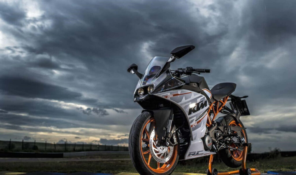KTM RC 390 Wallpaper: Sporty Motorcycle Against Dramatic Sky