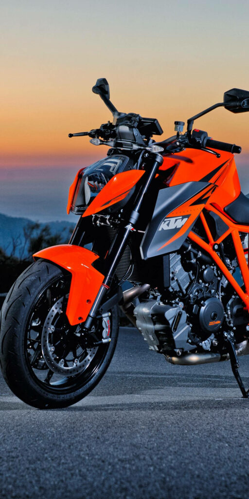 Bold KTM Bike Wallpaper: Dynamic Orange Sunset Background for iPhone
