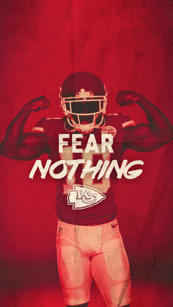 Kansas City Chiefs player flexing muscles on red background with Fear Nothing slogan and team logo Wallpaper