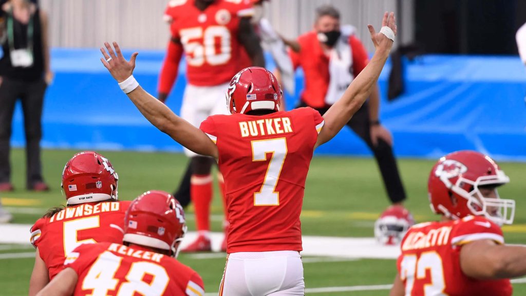 Kansas City Chiefs kicker Harrison Butker signals field goal in red uniform NFL wallpaper background