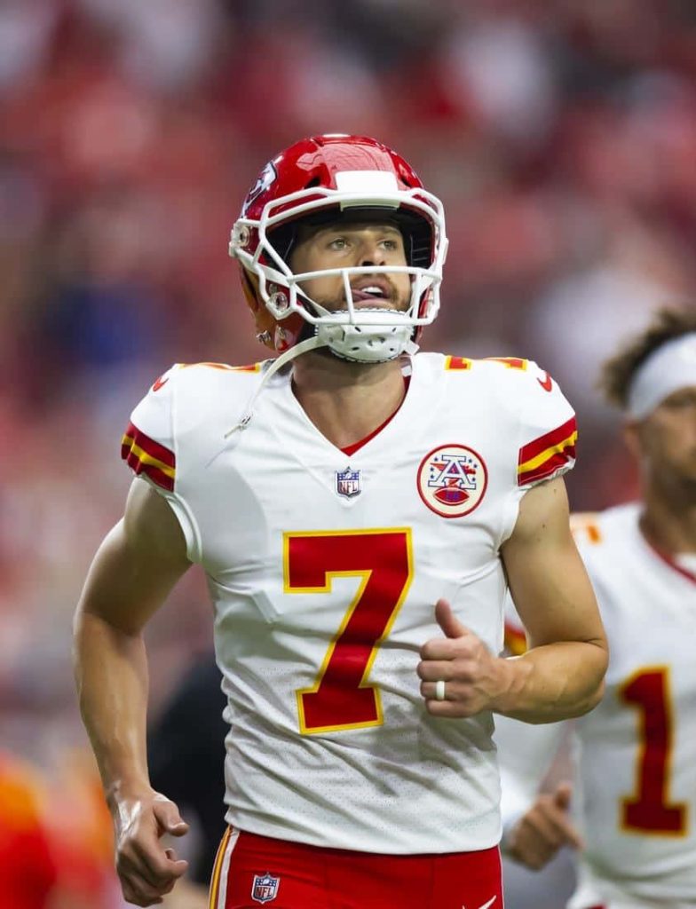 Kansas City Chiefs kicker Harrison Butker in white jersey red helmet intense NFL stadium wallpaper