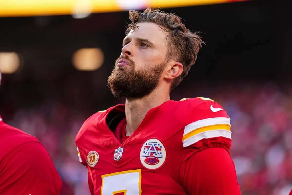 Kansas City Chiefs kicker Harrison Butker focused in red uniform stadium background wallpaper