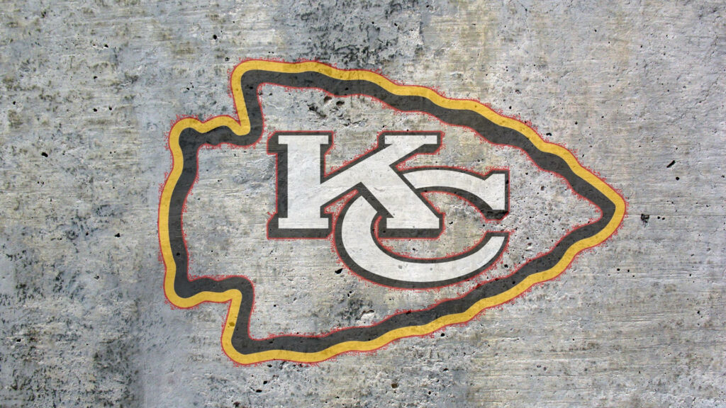 Kansas City Chiefs logo on textured concrete background bold NFL team rugged wallpaper
