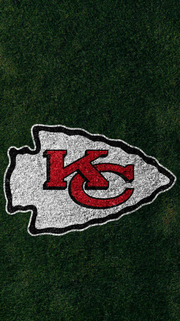 Kansas City Chiefs logo on textured football field wallpaper capturing game day energy