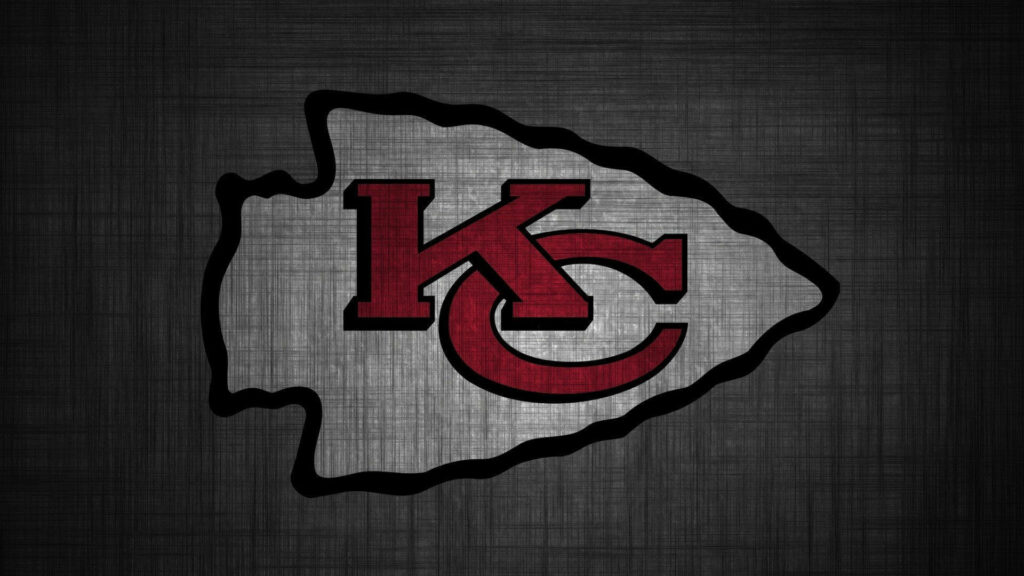 Kansas City Chiefs logo centered on textured gray background with bold red letters and black outline Wallpaper