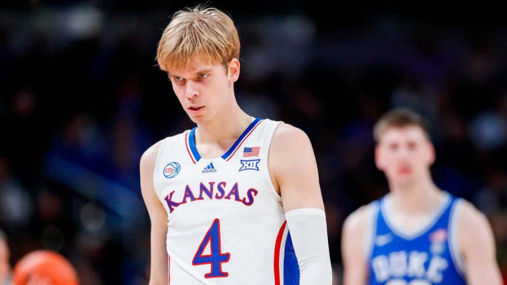 Kansas Jayhawks Gradey Dick in white jersey number 4 intense college basketball action shot Wallpaper