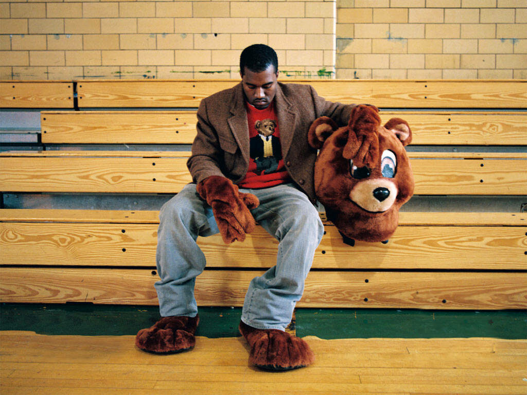 Kanye West Bear Mascot Wallpaper: Iconic Bleacher Style Background