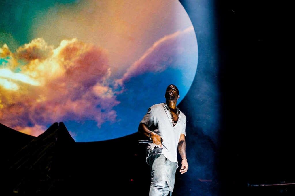 Vibrant Kanye West Wallpaper: Dramatic Oval Sky & Rainbow Hues