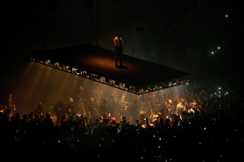 Kanye West Performing Live on Elevated Stage - Vibrant Concert Wallpaper
