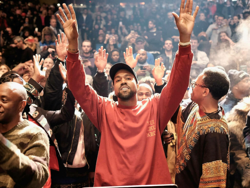 Kanye West Wallpaper: Celebrate under Bright Lights and Energized Crowd