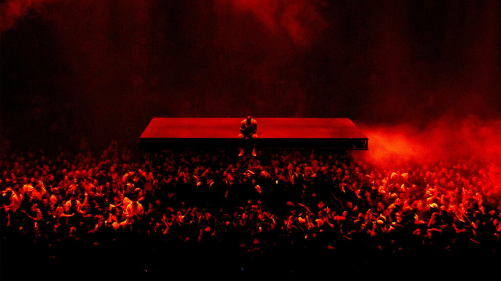 Kanye West's Mesmerizing Saint Pablo Show: Captivating Red-Lit Ambience as He Performs on Floating Stage Wallpaper