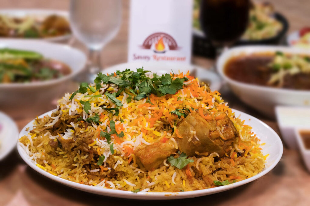 Karachi Chicken Biryani with aromatic rice succulent chicken pieces and fresh coriander garnish Wallpaper