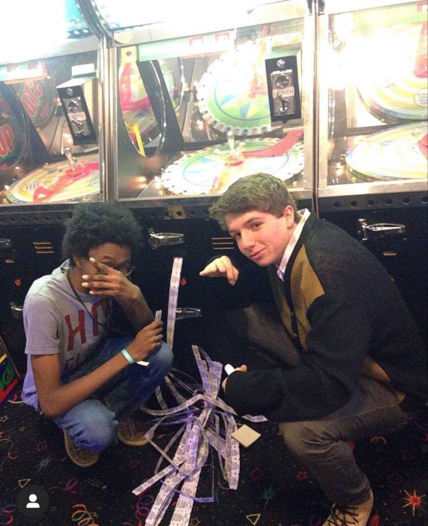 Karl Jacobs and friend at arcade kneeling by ticket games with winning tickets wallpaper background