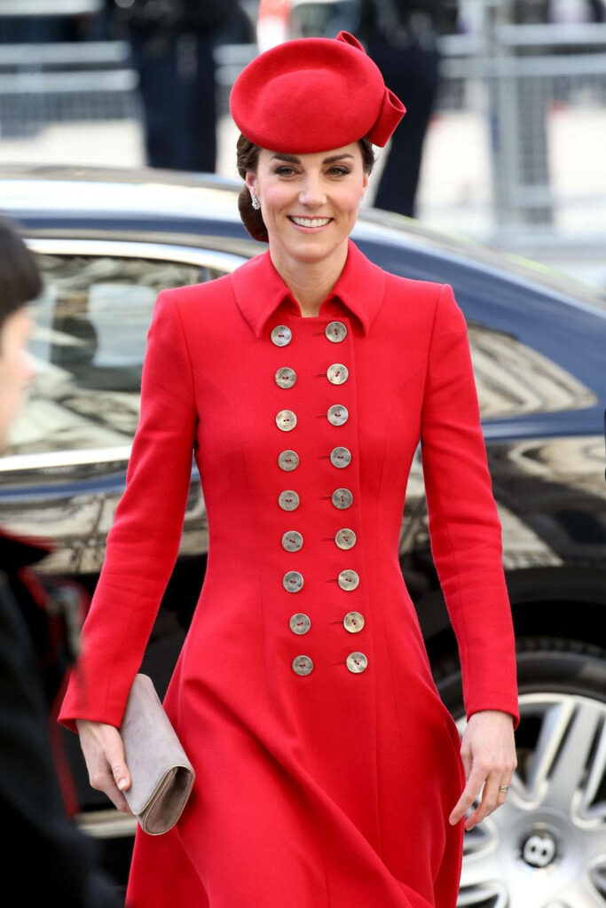 Kate Middleton in vibrant red buttoned coat and matching hat exuding elegance and grace wallpaper