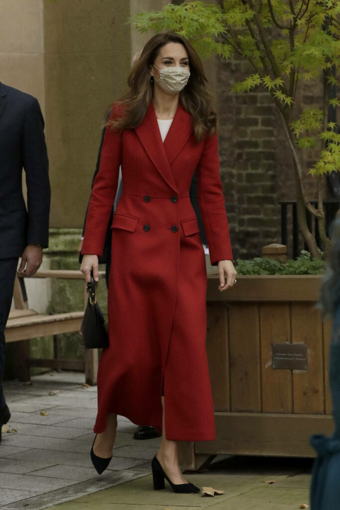 Kate Middleton in red overcoat and matching mask with black heels and handbag outdoors elegance Wallpaper