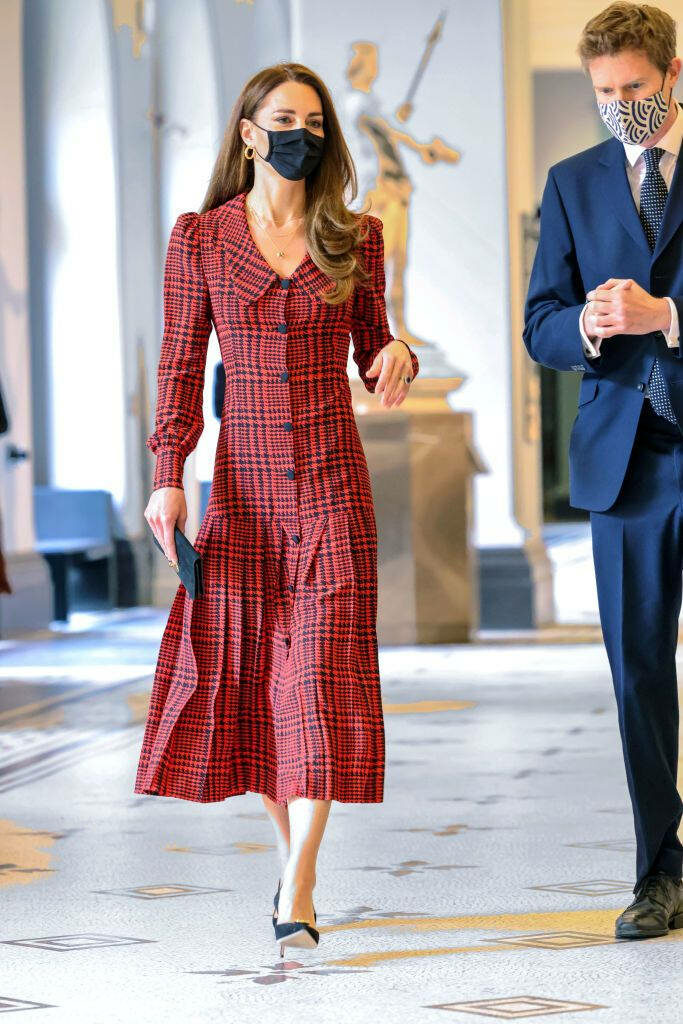 Kate Middleton in elegant rufous plaid dress walking indoors showcasing poise and style wallpaper