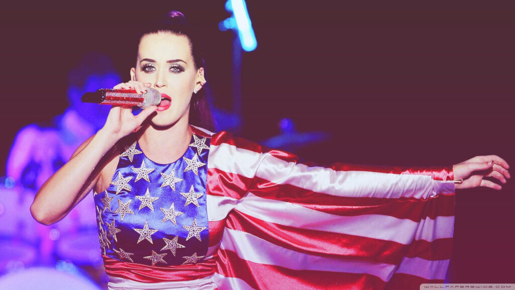 Patriotic Katy Perry: Energetic Performance in Flag-Themed Dress Wallpaper