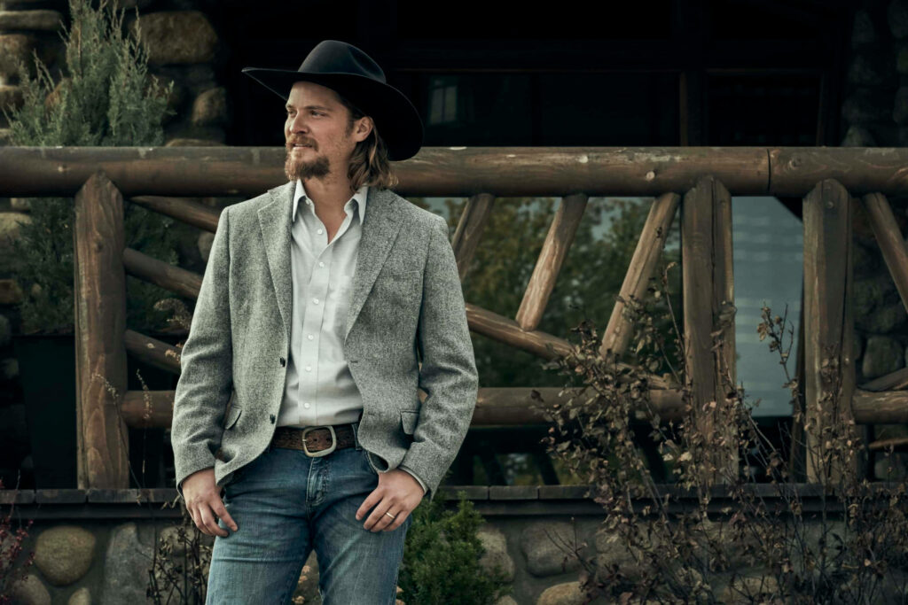 Rugged Kayce Dutton Wallpaper: Cowboy Charm on Rustic Background