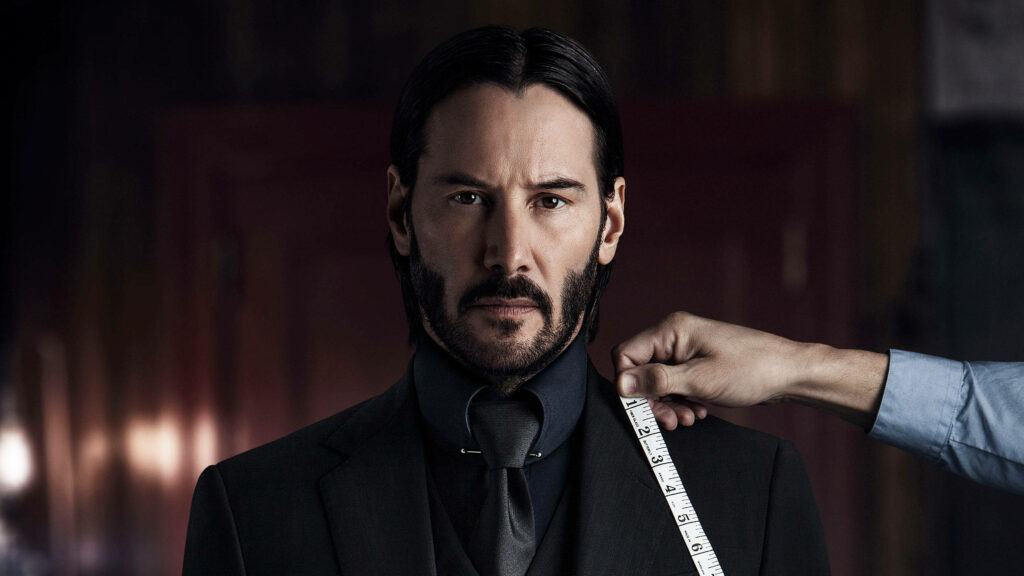 Keanu Reeves as John Wick Wallpaper: Intense Iconic Persona in Black Suit