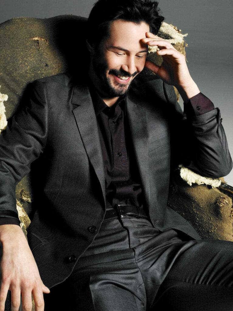 Keanu Reeves: Candid Charm in All-Black Outfit - Elegant Wallpaper