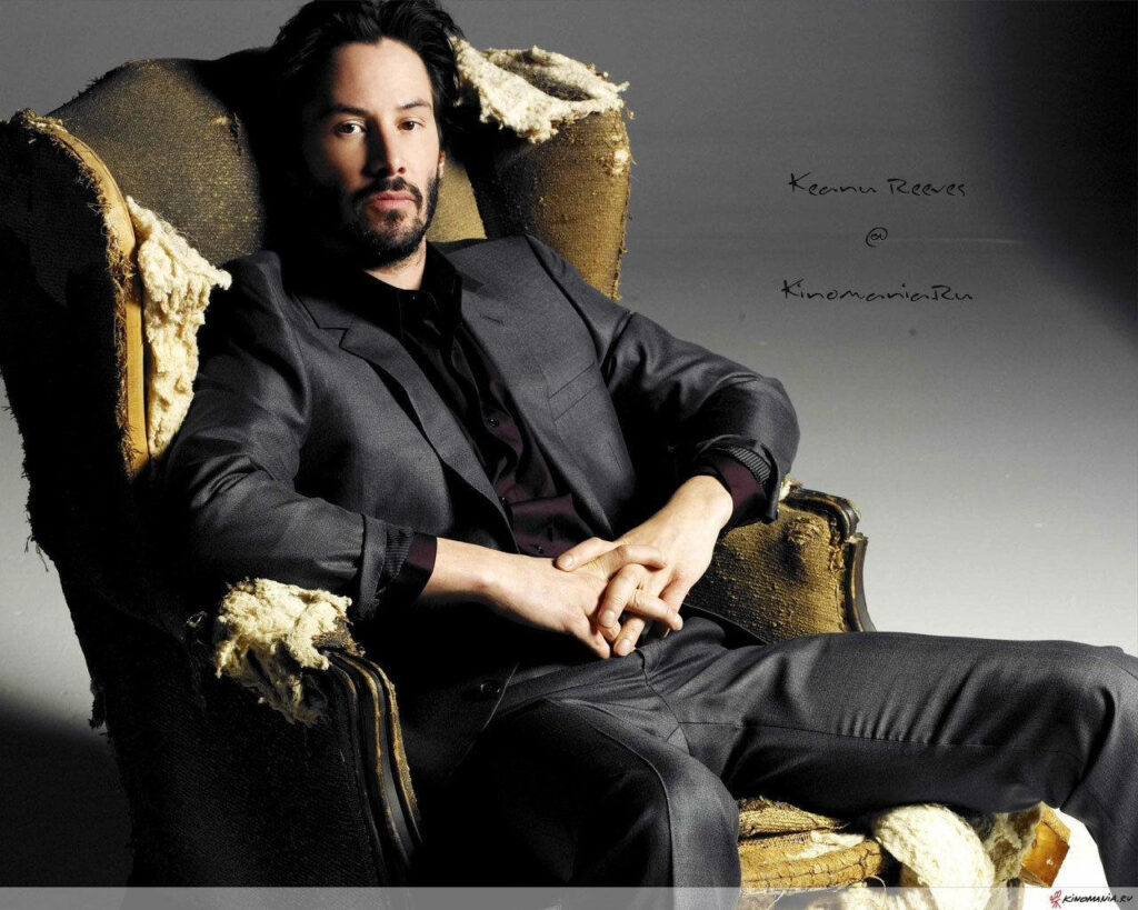 Keanu Reeves in a Sleek Black Suit: Sophisticated Wallpaper Background