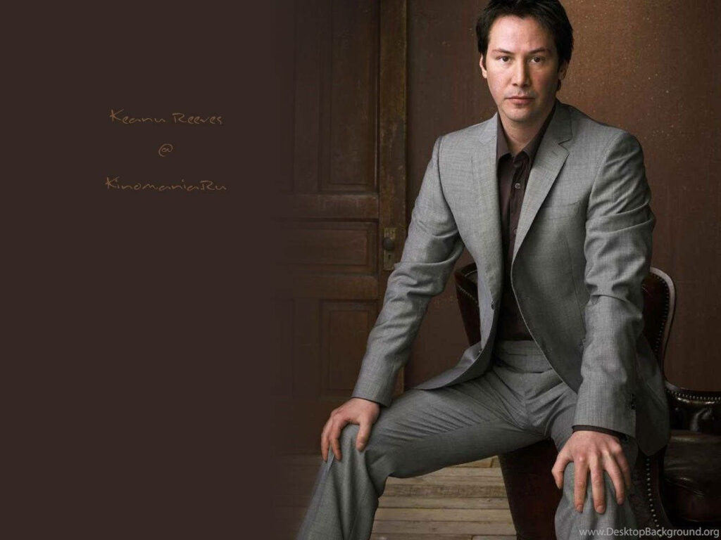 Stylish Wallpaper: Keanu Reeves in Gray Suit Against Elegant Backdrop