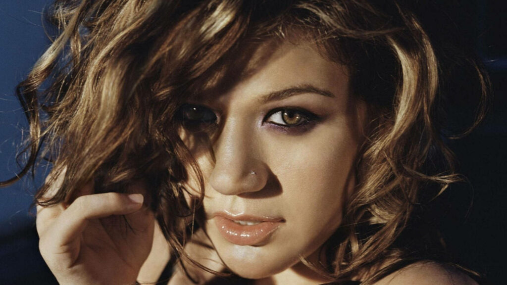 Kelly Clarkson close up intense stare tousled hair bold eye makeup wallpaper background portrait