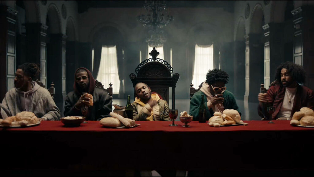 Kendrick Lamar at Dramatic Table: Artistic Wallpaper Background