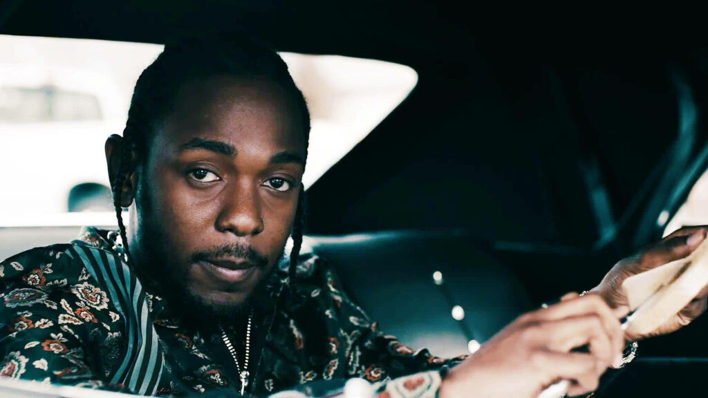 Kendrick Lamar Inside Car: Stylish Close-Up Wallpaper Background
