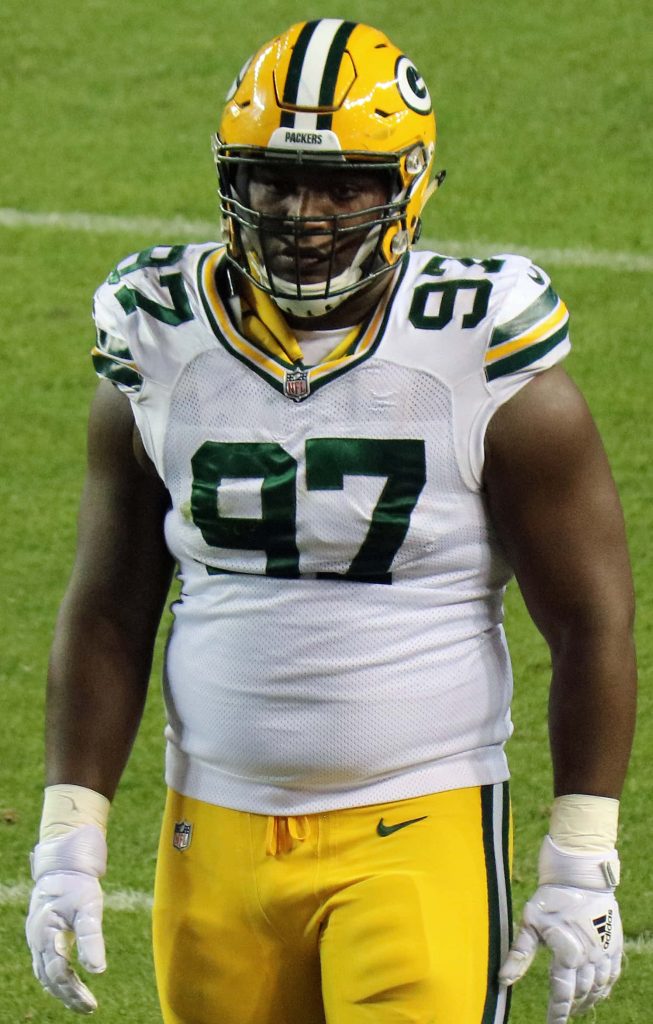 Kenny Clark Green Bay Packers defensive tackle in white uniform game action NFL wallpaper