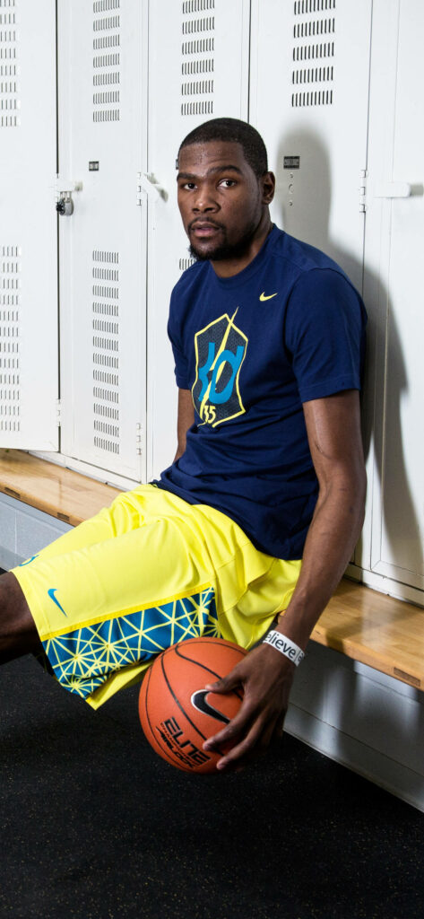 Kevin Durant Locker Room Wallpaper: Focused Star with Basketball