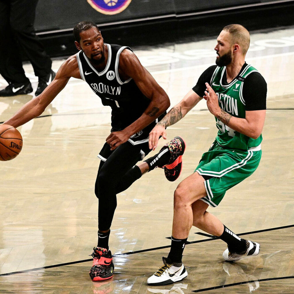 Evan Fournier Celtics and Kevin Durant Nets intense NBA action on polished basketball court wallpaper