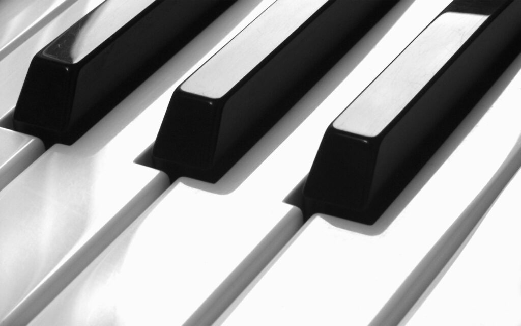 Majestic Melodies: Exploring the Musical Whirlwind of Black and White Piano Keys Wallpaper