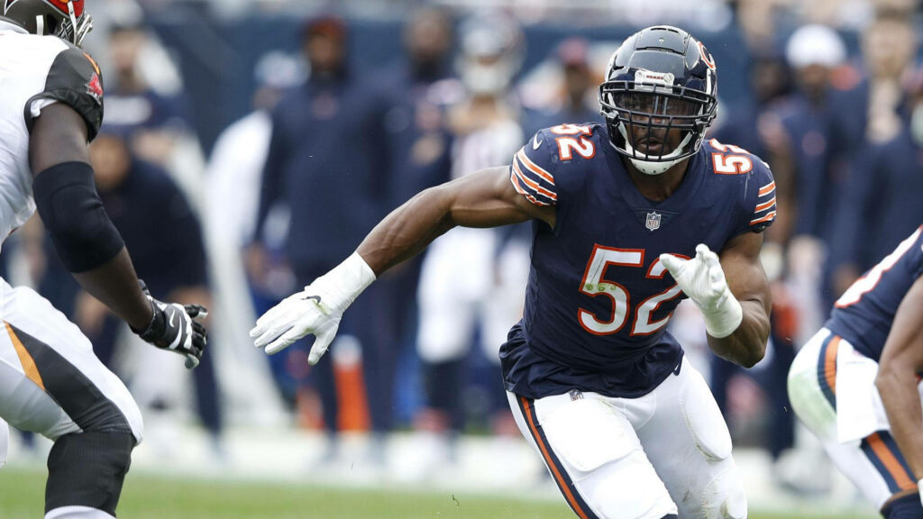 Khalil Mack Chicago Bears NFL player charging forward in navy orange uniform dynamic action Wallpaper