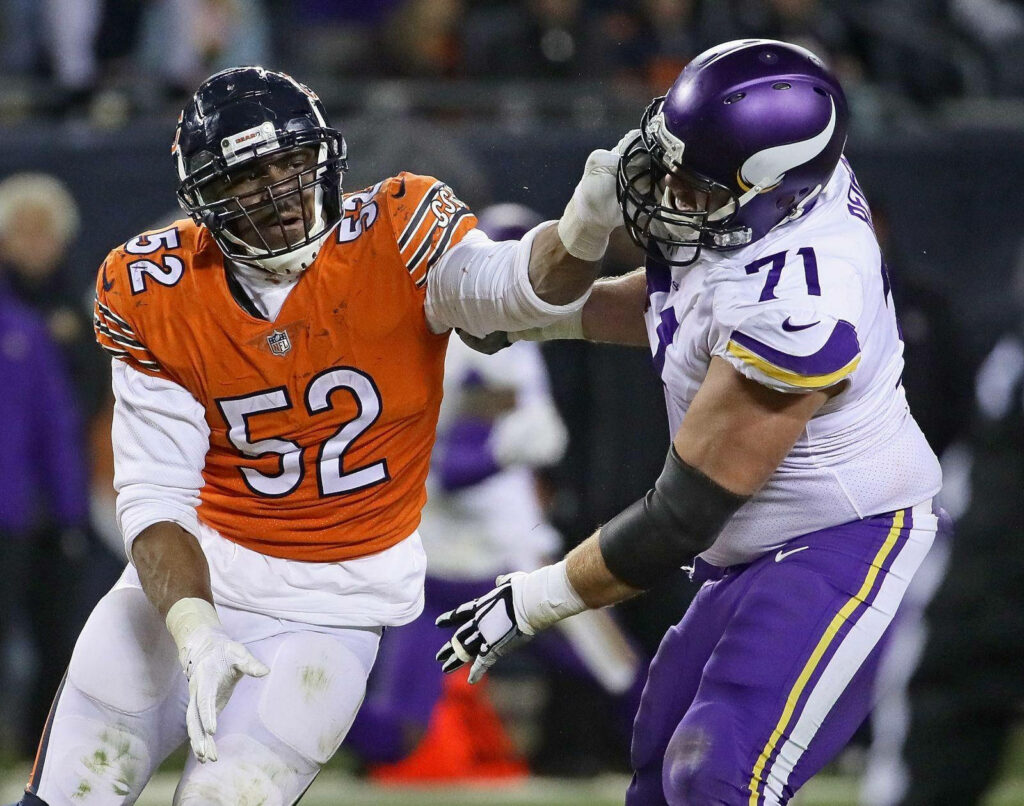 Khalil Mack Chicago Bears in orange jersey dominating NFL game action against rival player wallpaper