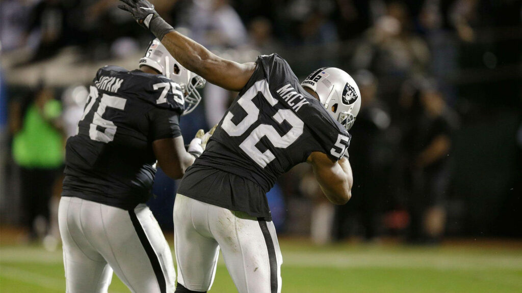 Khalil Mack #52 powerful linebacker in action NFL wallpaper bright stadium lights intense game