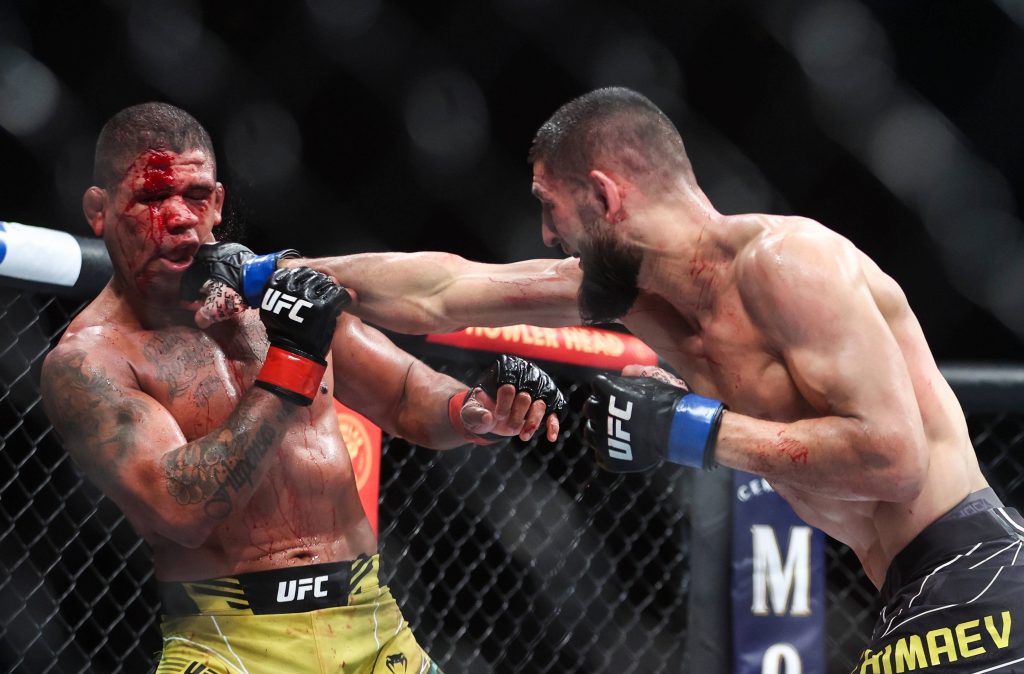 Khamzat Chimaev strikes bloodied Gilbert Burns in intense UFC Octagon MMA fight wallpaper