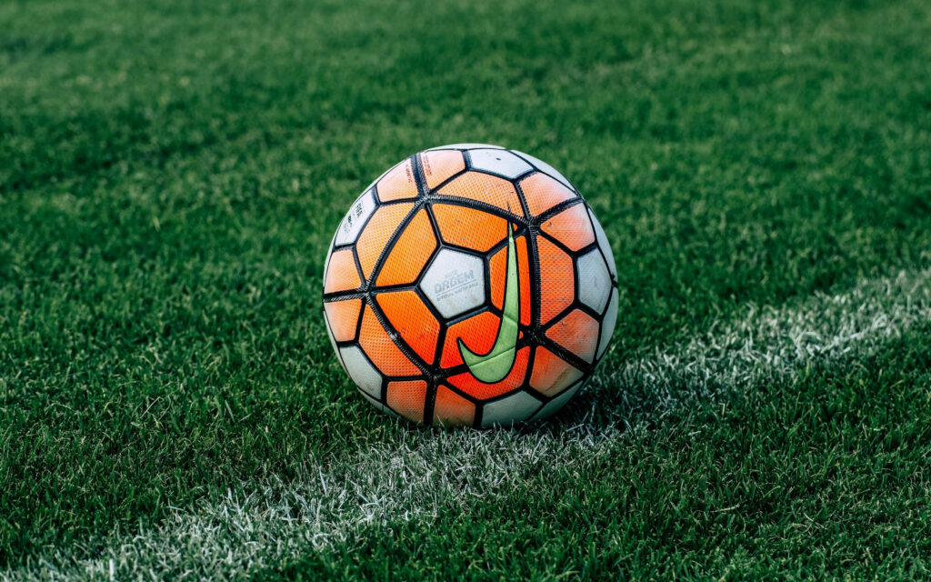 Kick-off Excitement: Vibrant dual-colored soccer ball sets the field ablaze Wallpaper