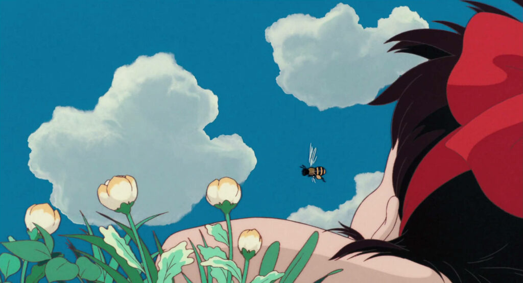 Kiki's Dreamy Meadow: Wallpaper of Kiki Lying Among Blooming Flowers
