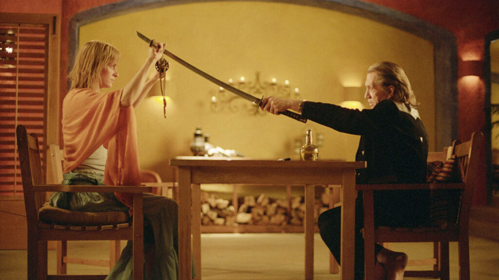 Kill Bill wallpaper The Bride and Bill face off with swords drawn intense movie showdown