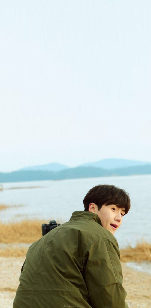 Kim Seon-ho serene candid pose olive green jacket camera lakeside blurred background wallpaper