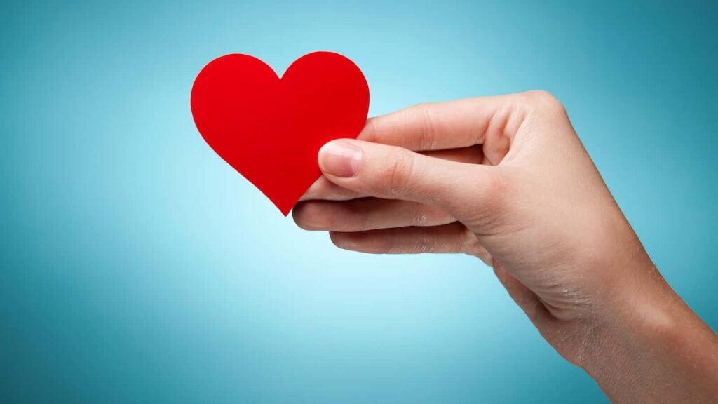 Kindness & Compassion: Red Heart on Soft Blue Wallpaper Background
