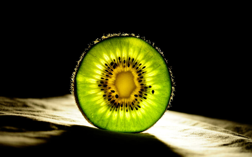 Mesmerizing Light Patterns Illuminate a Captivating Slice of Kiwi Wallpaper